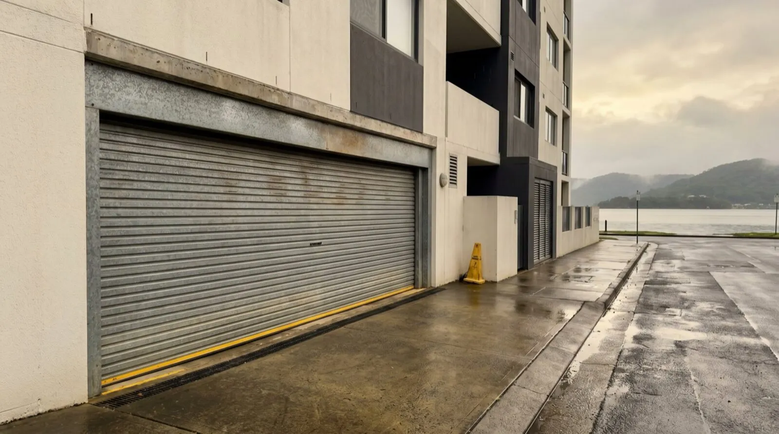 A roller door on the basement carpark of a waterfront apartment building at Point Frederick